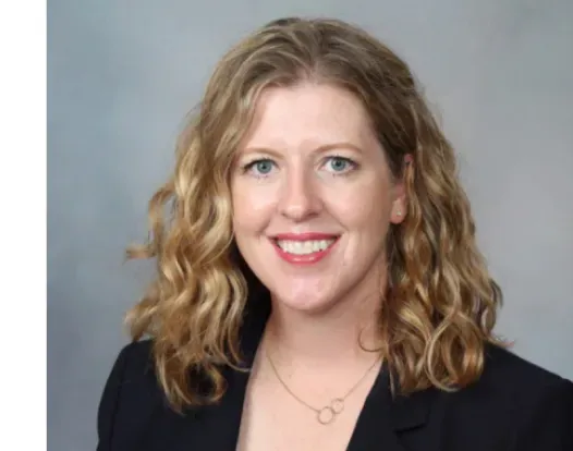 Headshot of Dr. Wendy Allen-Rhoades. She is smiling, facing forward. She is wearing a black blazer over a white shirt, with a smal golden necklace. Her hair is light brown and shoulder-length.