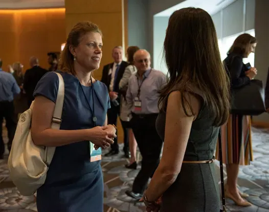 ASCO members chatting at a meeting