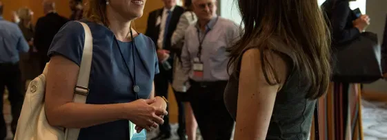 ASCO members chatting at a meeting