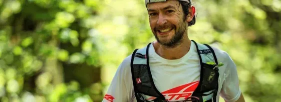 Dr. Justin Grunewald running a distance race in athletic gear.