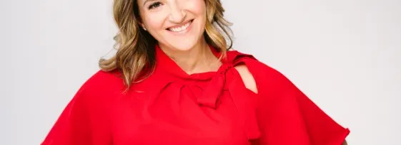 Melissa Berry in a red blouse smiling facing forward