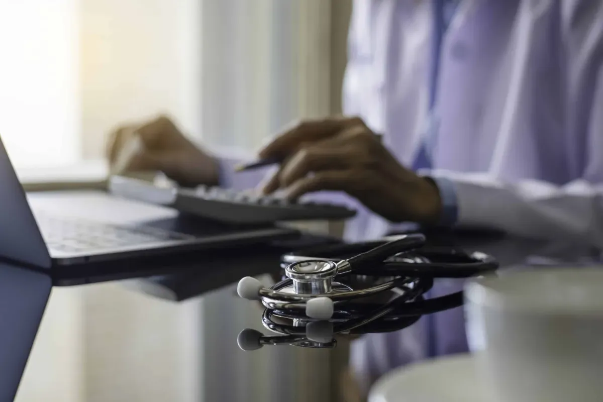 hands typing and stethoscope