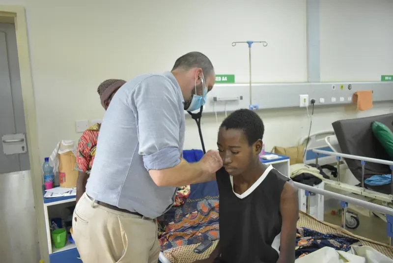 Dr. Painschab providing care for a patient in the clinic.