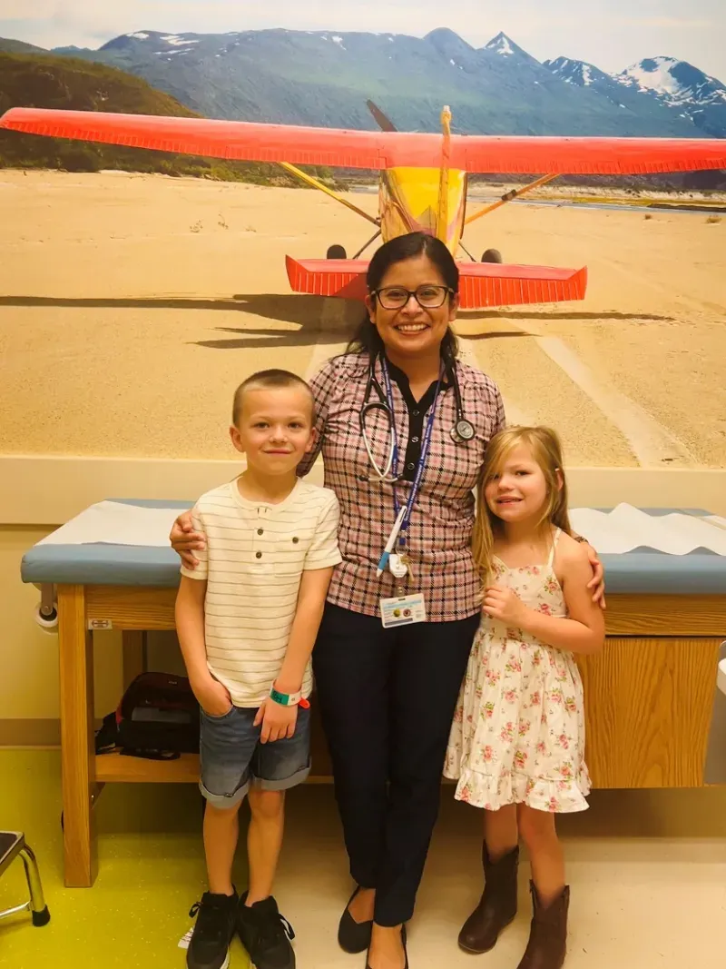 Dr. Jenny Ruiz standing between Leo and Leo's sister.
