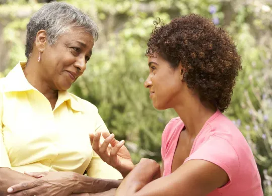 A mother and her daughter shown connecting through heartfelt conversation.