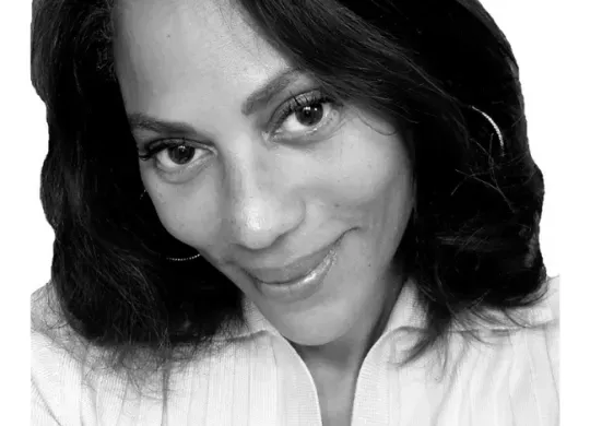 Monique Robinson smiling facing forward. The image is a black and white close-up of Monique's face.