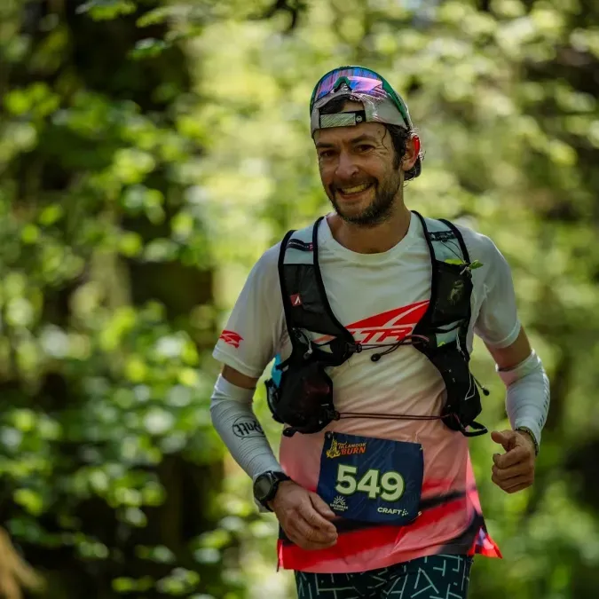 Dr. Justin Grunewald running a distance race in athletic gear.